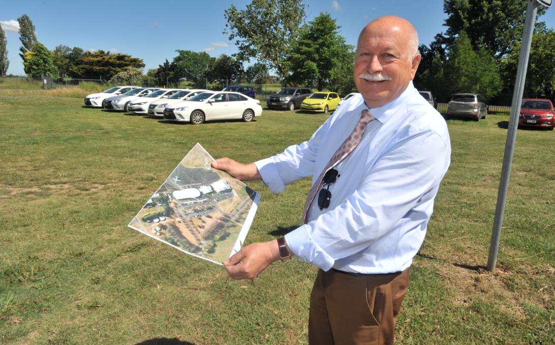 MEETING DEMAND: Councillor Chris Gryllis at the future long-term parking site at Orange Airport where people already park on the grass. Photo: JUDE KEOGH 1209jkairport1