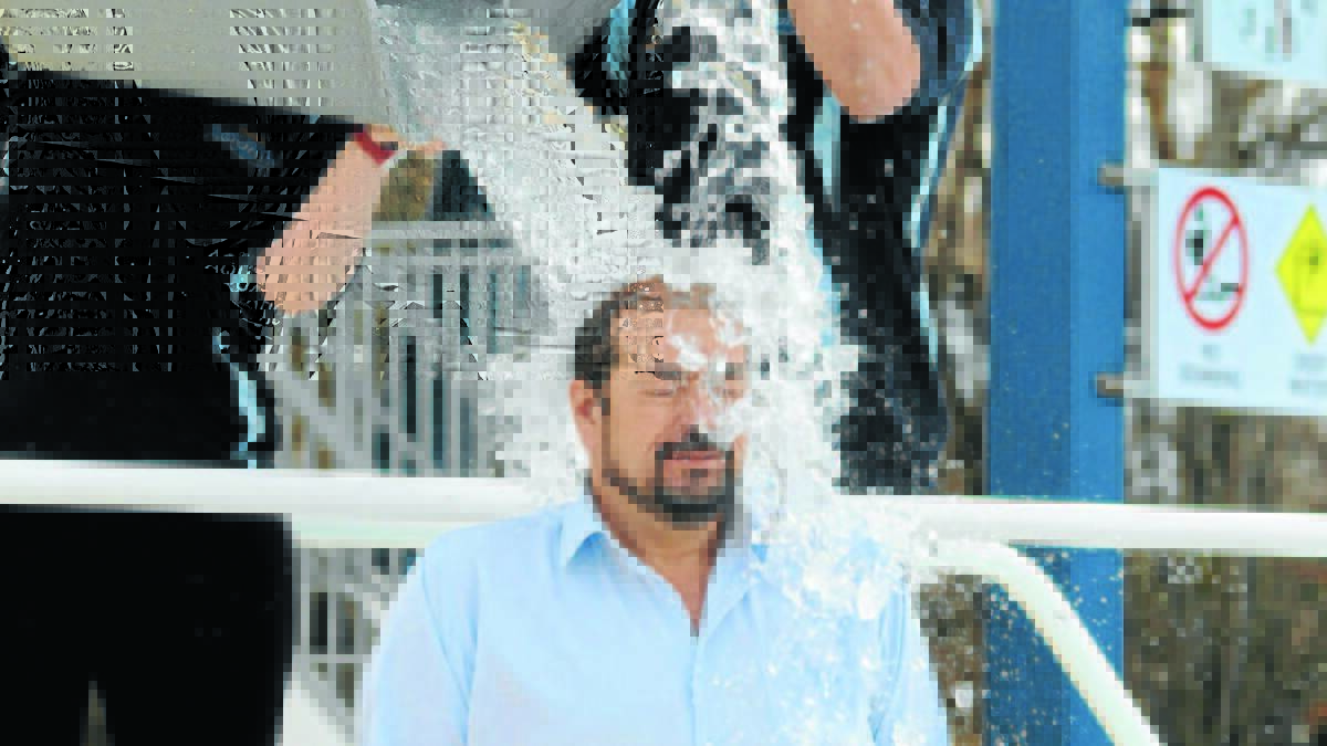 Orange City Council general manager takes one for the team as part of the Ice Bucket Challenge in 2014.