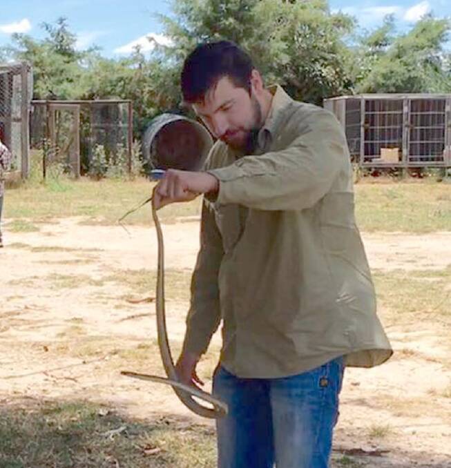 COVERING COSTS: Jake Hansen with a snake at Lyndhurst.