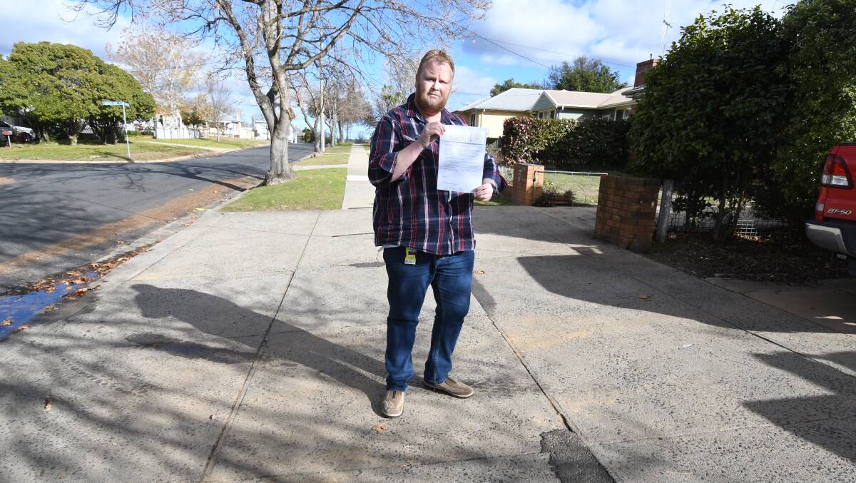HEFTY FINE: Ben Humphreys was fined $263 for parking in his driveway. Photo: JUDE KEOGH 0605jkparking1