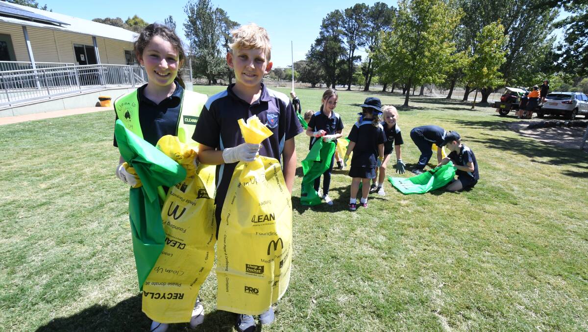 CARING FOR PLANET: Clergate Public School students Olivia Zell and Maklin Henderson and their classmates were part of Clean Up Australia Day. Photo: JUDE KEOGH
