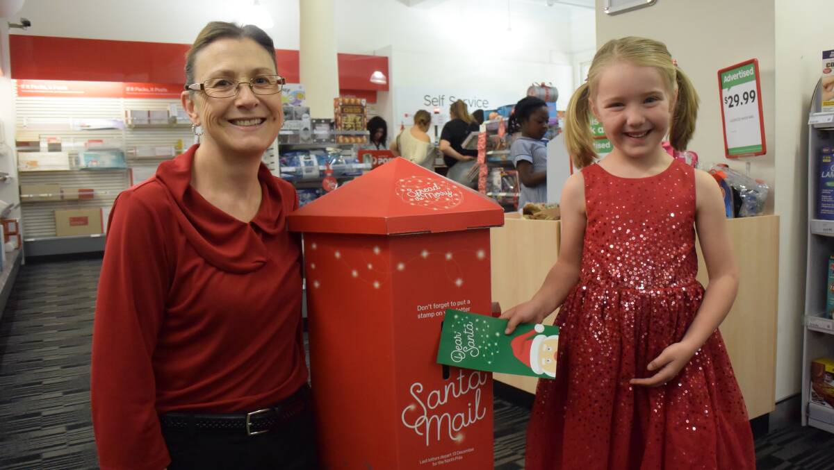 WISHLIST: Orange postal manager Fiona McGinley with five-year-old Arienne Casey, who has written to Santa. Photo: DANIELLE CETINSKI