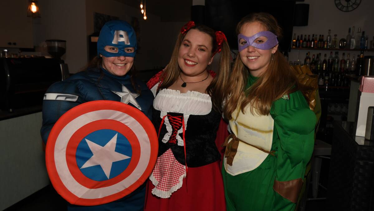 OPEN FOR BUSINESS: Mac-ATTIRE Costume Hire held a scavenger at Blind Pig Bar and Cafe when it reopened on Saturday. Pictured are Bree Byrne, Georgi Lincoln and Kelsea Bellamy.