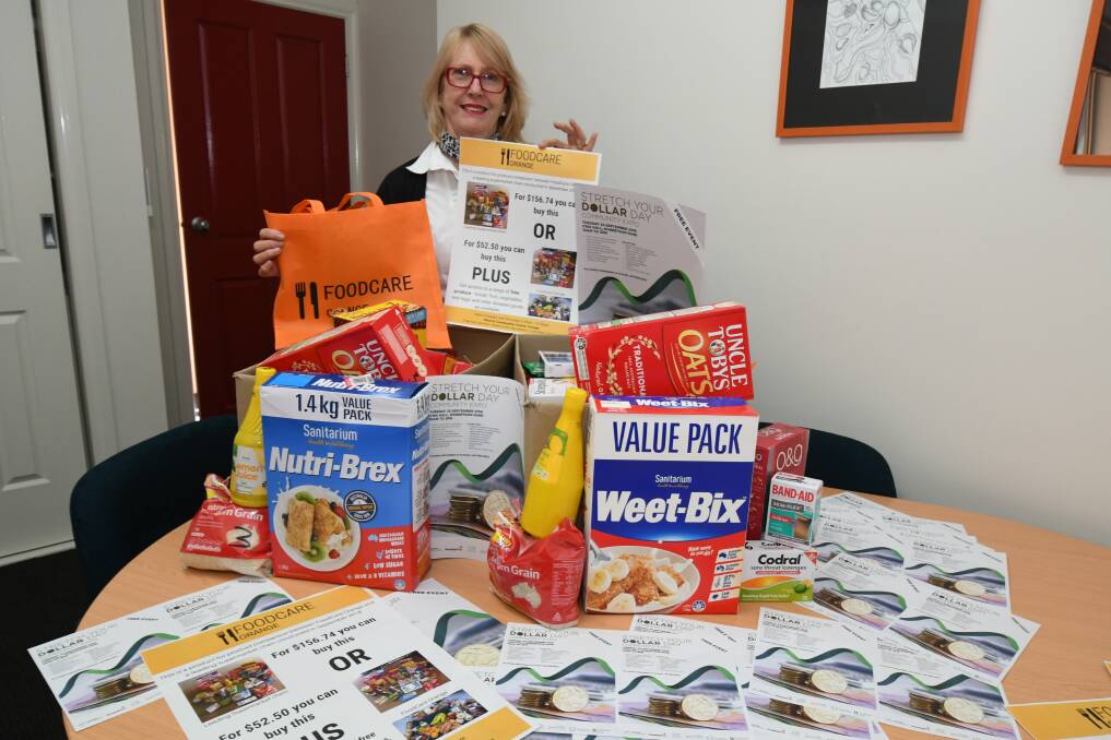 MORE FOR LESS: Orange City Council community development co-ordinator Karen Boyd with Tuesday's food display. Photo: JUDE KEOGH 0920jkfood2