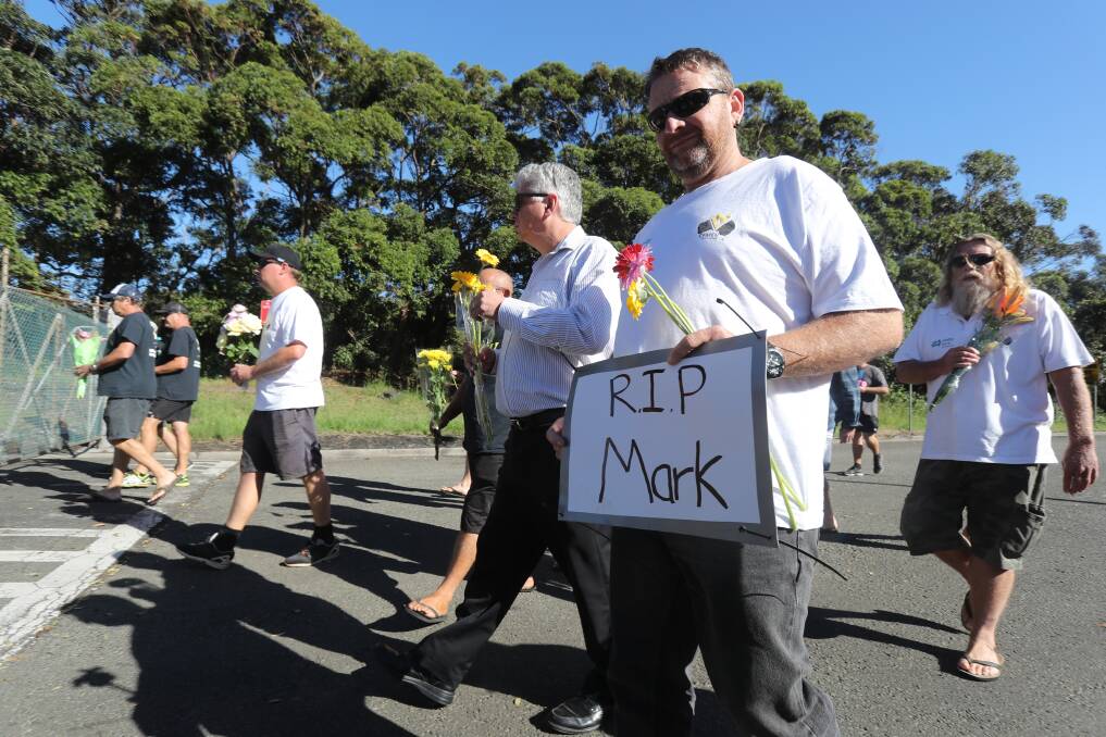 RIP: Union workers left flowers on the locked coal terminal gate in honour of their colleague. Picture: Robert Peet