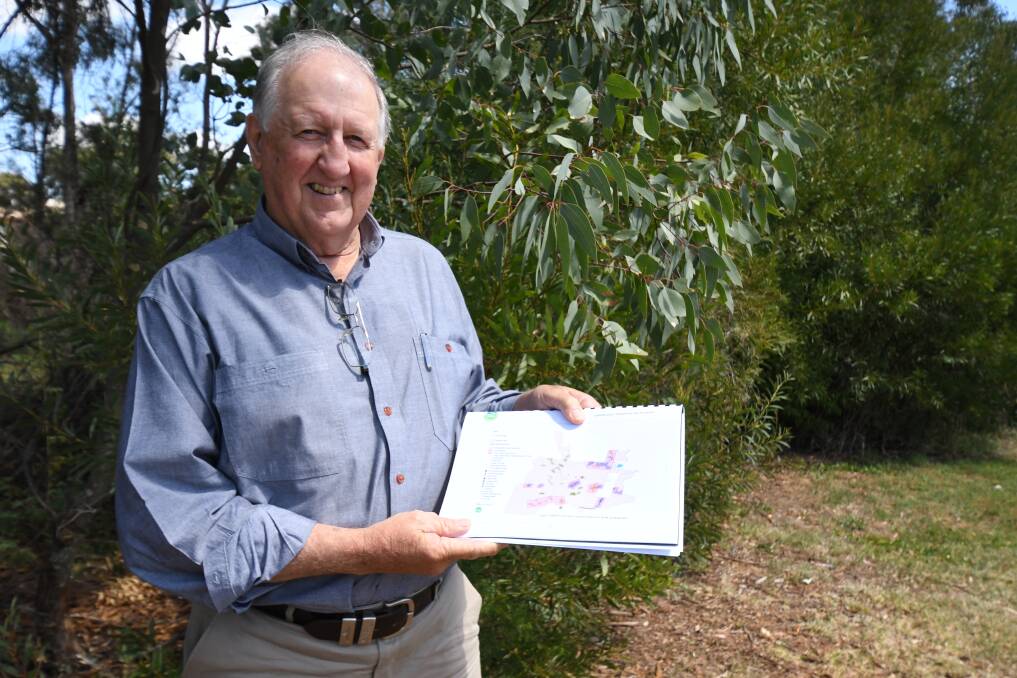 CONCERNS: Dr Colin Bower shows part of his report in the mountain's biodiversity. Photo: JUDE KEOGH