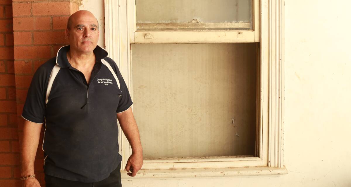 No view: Eddie Eid stands in front of his upstairs premises where the window view has been blocked by a concrete wall from the construction site next door. Photo: PHIL BLATCH