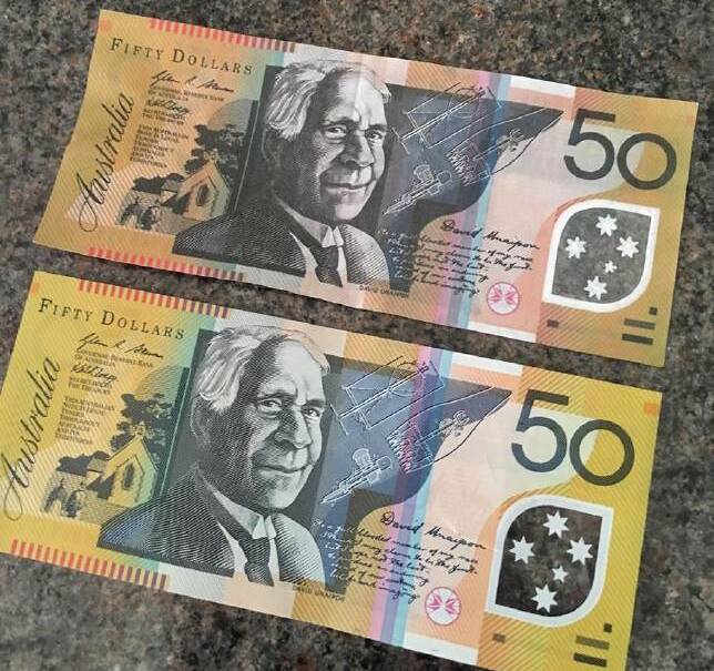 DODGY NOTES: Fake $50 notes were circulated in Orange this year. The darker note at the top was counterfeit.
