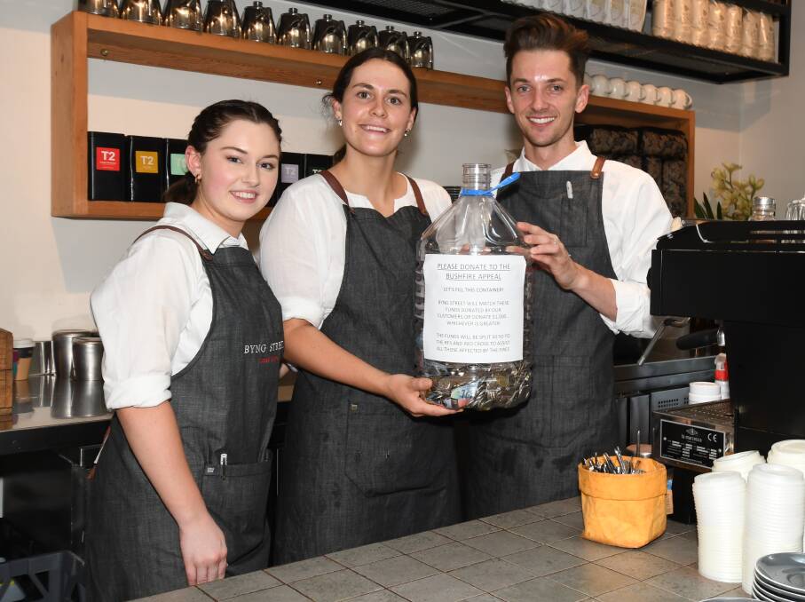 HELPING OUT: Lily Campbell, Charlotte Hogg and Jye Clarke with funds raised for bushfire relief at the Byng Street Cafe. Photo: CARLA FREEDMAN 0113cfbyngst3
