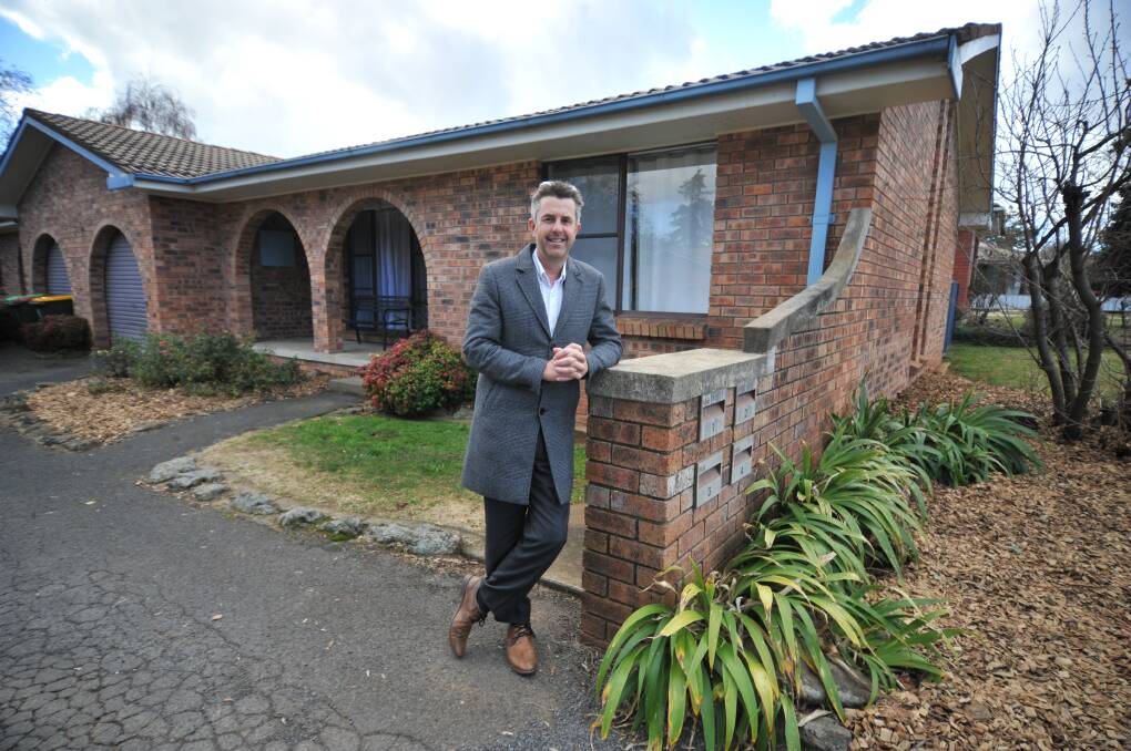 RISING PRICES: Real estate agent Ash Brown at a Sampson Street unit for sale for up to $390,000. Photo: JUDE KEOGH