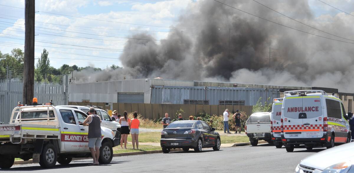 BLACK SMOKE: Thick clouds emanate from the burning car yard next door to the RSPCA shelter during Saturday's blaze. Photo: JUDE KEOGH