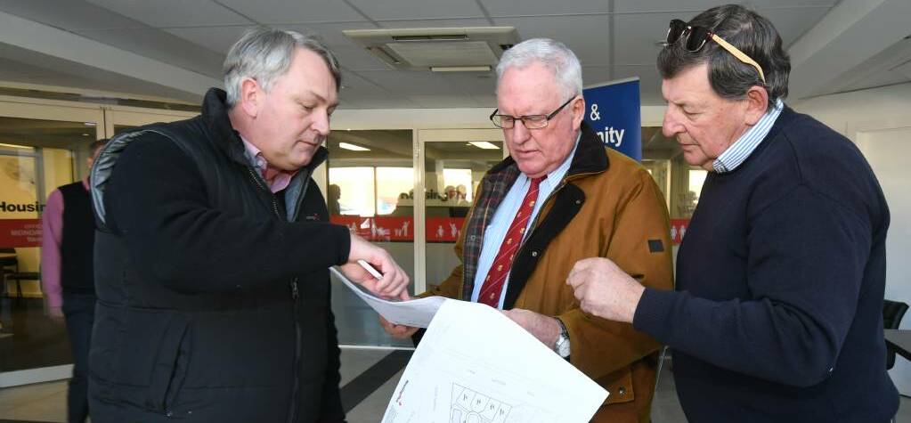 PLANS: David Fisher, Rick Colless MLC and Cr Reg Kidd examine plans for the domestic violence crisis centre. 