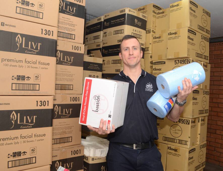 SUPPLIES: Josh Turnbull with some of the club's stock of toilet paper, tissues and cleansers it is offering to care services. Photo: JUDE KEOGH