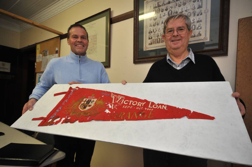 CITY'S GENEROSITY: Grant Jaeger and Bob Curran with the war banner donated to the historical society. Photo: JUDE KEOGH