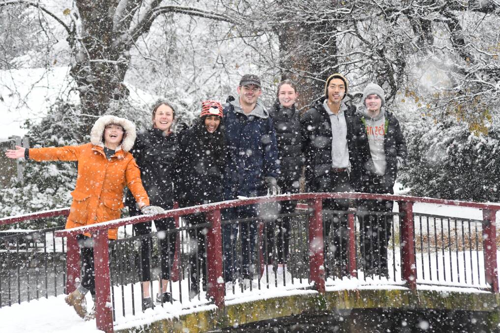 PLACE TO BE: Jiyoon Lee, Izzy Nilsson, Trisha Narula, Dominic Cooper, Anna Penfold, Jerry Yu, Kieran Cook in the snow in Cook Park. Photo: JUDE KEOGH