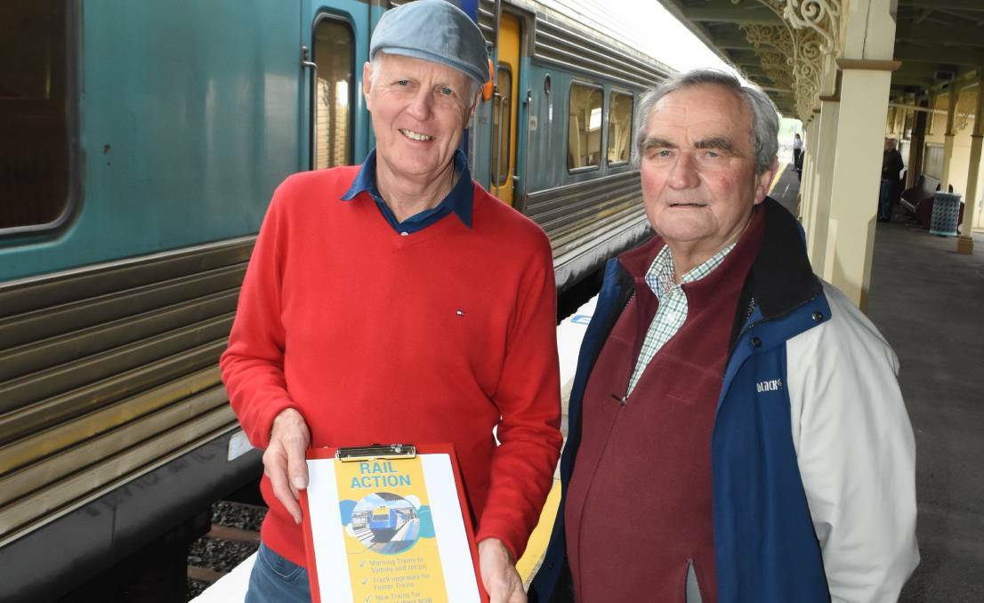 PETITION: Orange Rail Action Group members Neil Jones and Dr Peter Bilenkij helped collect signatures calling for a better train service.
