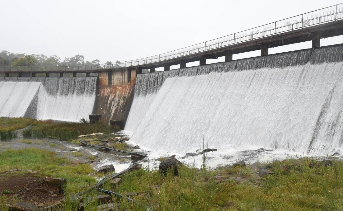 BIG WET: Water gushes over the spillway at Lake Canobolas on Tuesday. Photo: CARLA FREEDMAN