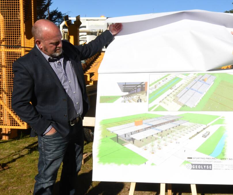 SPORTS: Cr Jason Hamling, seen examining plans for the $25 million sporting complex at Jack Brabham Park, has also called for shelters for Bernie Stedman Field, which is also at the park. Photo: JUDE KEOGH
