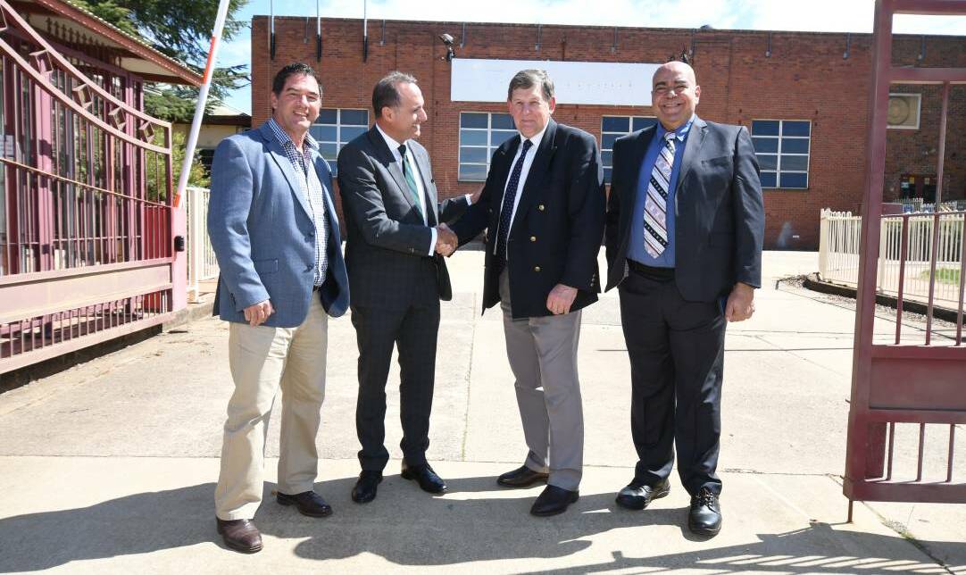 DONE DEAL: Cr Tony Mileto, Barry Barakat, Cr Reg Kidd and Numan Al Gharini at the former Electrolux factory site this year when it was announced aluminium company A-Tech would be moving in. Photo: CARLA FREEDMAN