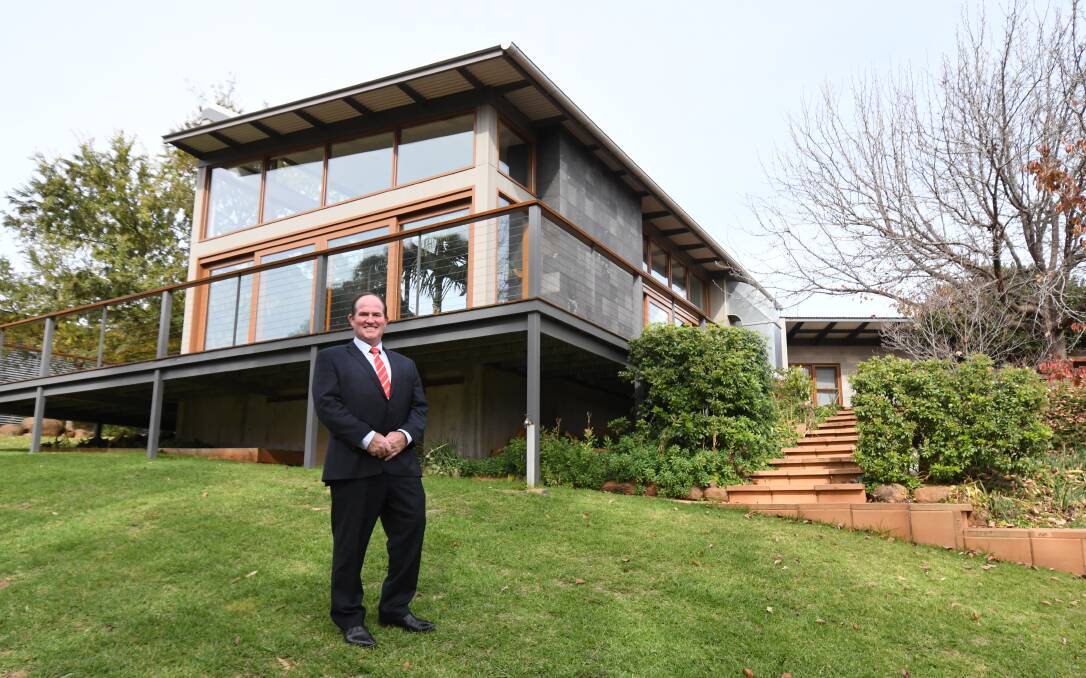 LUXURY LIVING: LJ Hooker agent Alistair Miller at a property on The Escort Way just out of town which is for sale at $1.85 million. Photo: JUDE KEOGH