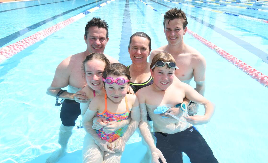 FAMILY SWIM: Dan, Kate, Lucinda, Sonya, Henry and Will Cornally enjoy a cool dip in the outdoor pool on Monday. Photo: JUDE KEOGH 0939jkpool3