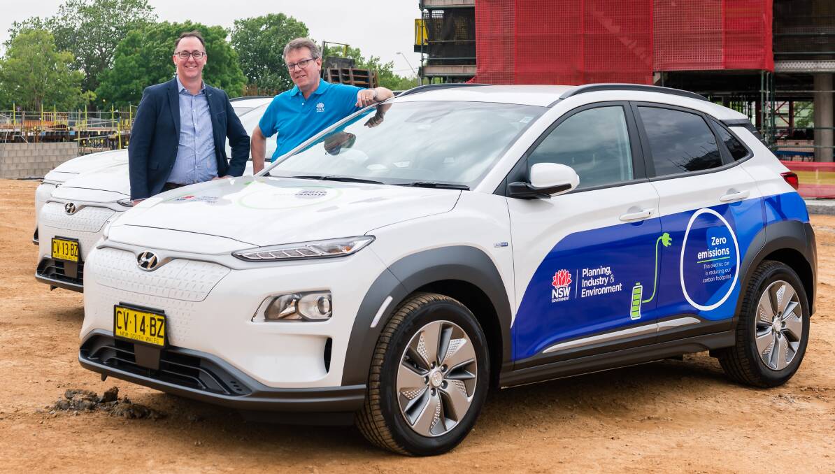 PLUG IN: Shaun Smith and Jim Betts with the new cars. Photo: Supplied, Rachel Gordon.