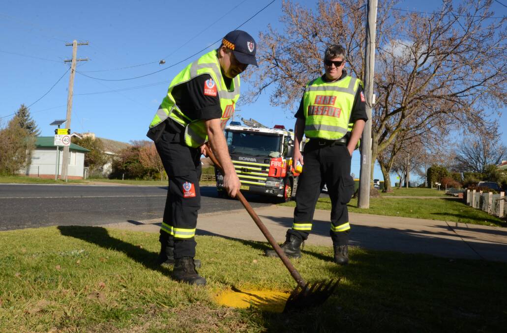 CLEANING UP: Senior Fire Fighter James Patrech and Senior Fire Fighter Mark Bell work on a hydrant in Anson Street. Photo: JUDE KEOGH
