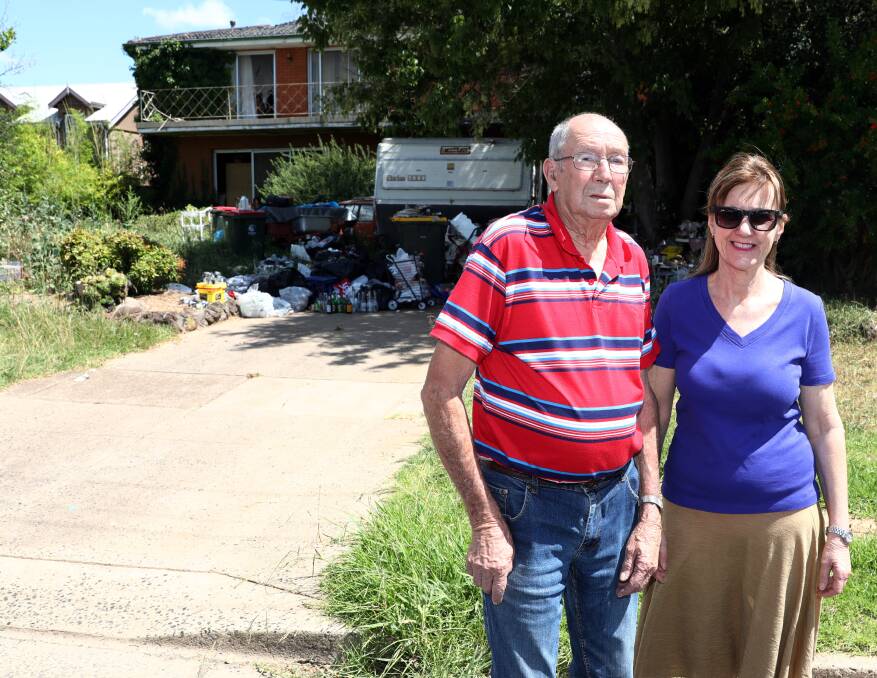 FED UP: Brian Lobley and Jeanette Pieszko are calling on council to find a solution to the problems created through rubbish piling up on this property in Windred Street. 