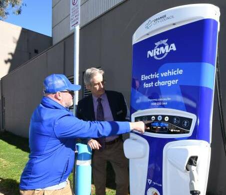 ELECTRIC SWITCH: The DPI move adds to the electric car initiative by Orange City Council with the installation of a fast charging station in Orange in July with James Simmons and Cr Stephen Nugent examining it.