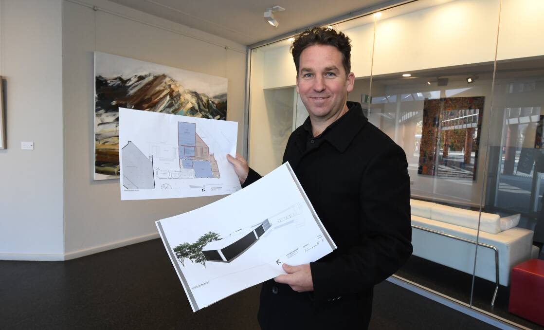 HIGH HOPES: Orange Regional Gallery director Brad Hammond with the plans for the gallery extension in May last year. Photo: JUDE KEOGH 0531jkgallery4