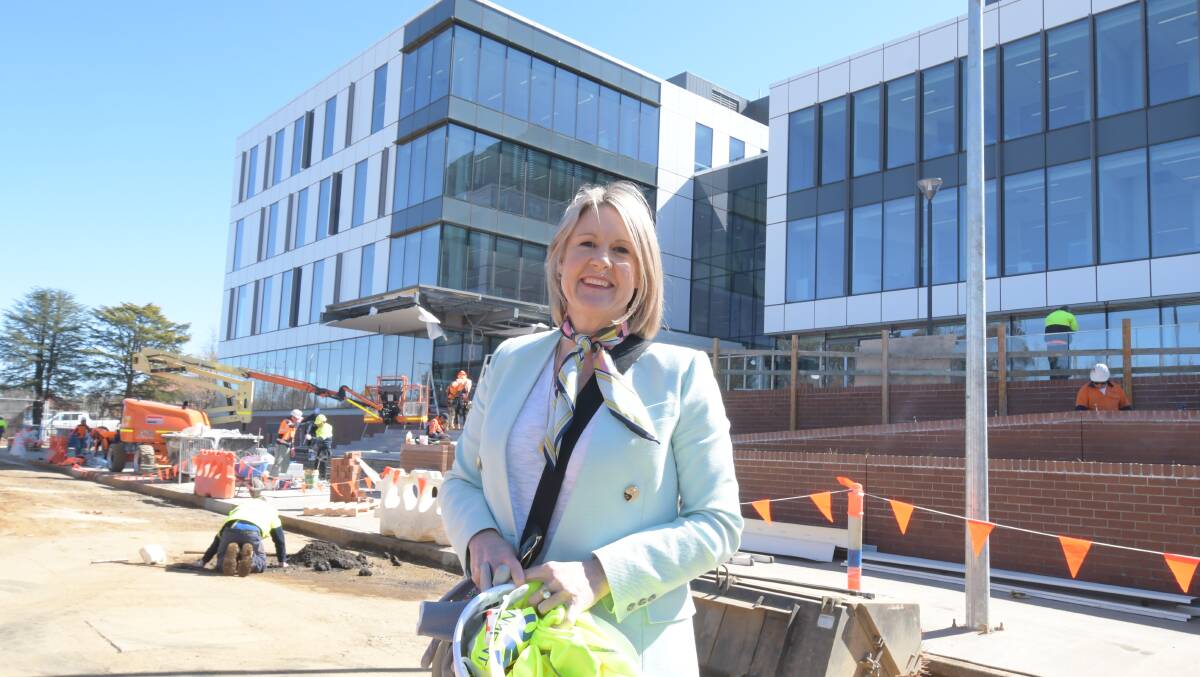 MOVING IN: The DPIE's Caroline Myers outside the entrance to the new DPI and state government offices building in Prince Street this week. Photo: JUDE KEOGH