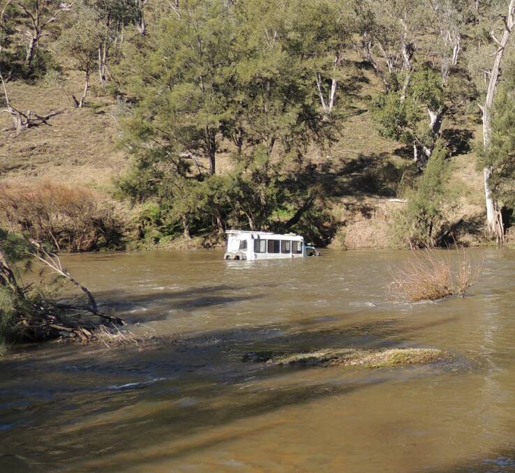 STUCK: The van was still in the Macquarie river at the Dixons Creek Long Point Crossing on Monday. Photo: Supplied