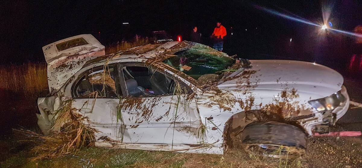 CRASH SCENE: The extensively damaged stolen car after it crashed into a paddock off Dairy Creek Road. Photo: TROY PEARSON/TOP NOTCH VIDEO