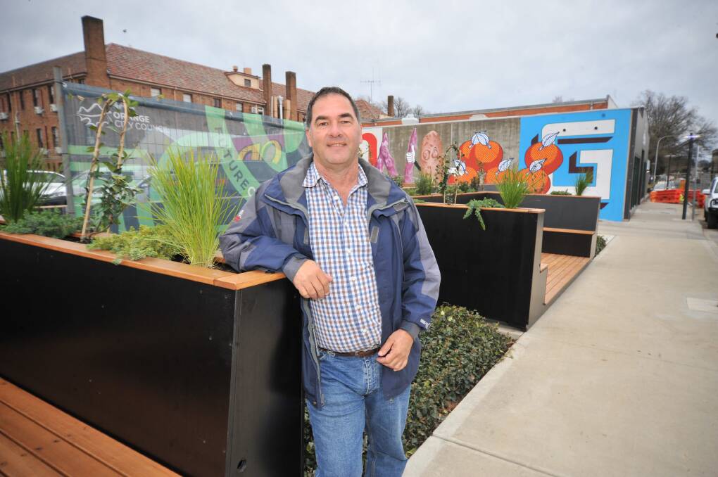 NEW BOOTHS: Cr Tony Mileto with the seats in McNamara Street which are part of the Future City revamp. Photo: JUDE KEOGH