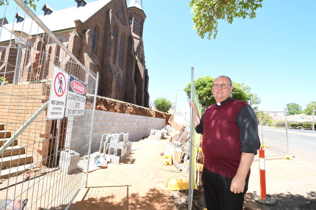 WORK SITE: Father Greg Bellamy at St Joseph's church in Hill Street where a retaining wall is underway before the replacement heritage wall is built. Photo: JUDE KEOGH