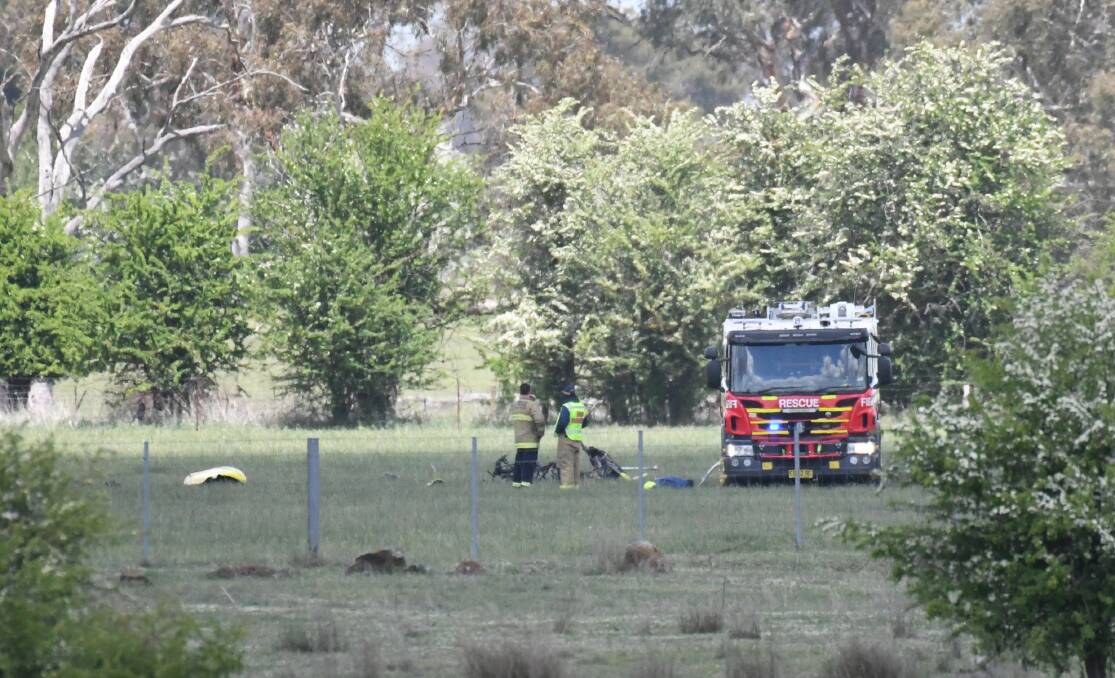 CRASH SCENE: Emergency crews attend the farmland site where the gyrocopter crashed near Orange airport on Wednesday. Photo: JUDE KEOGH 1031jkcrash2