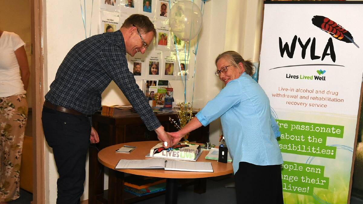 ANNIVERSARY: Lives Lived Well CEO Mitchell Giles and Wyla manager Pnina Smith cut the one-year cake. Photo: CARLA FREEDMAN 