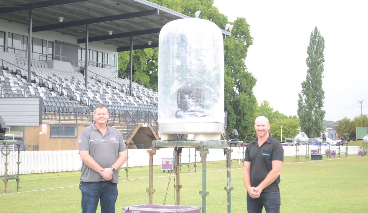 WEATHER PROTECTION: Organiser Craig McMahon and Shannon Brooks with laser show equipment being set up around Wade Park. 