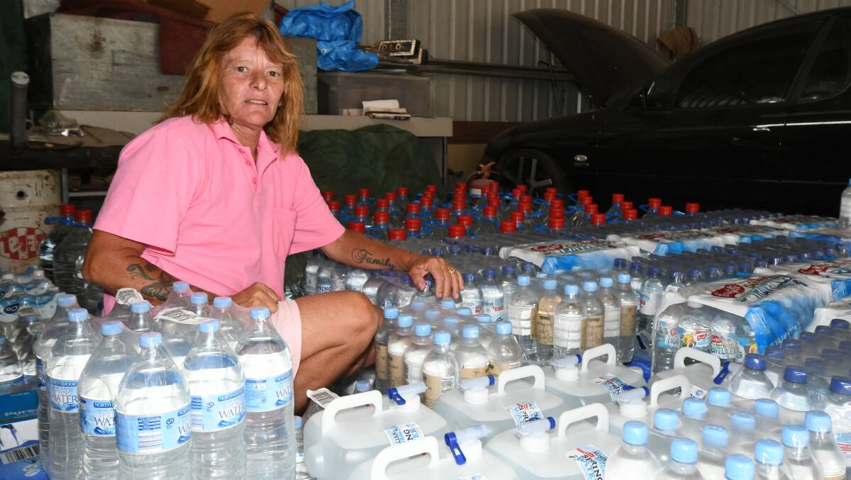 GENEROUS: Maree Glohe with water bottles donated by people in Orange. Photo: CARLA FREEDMAN