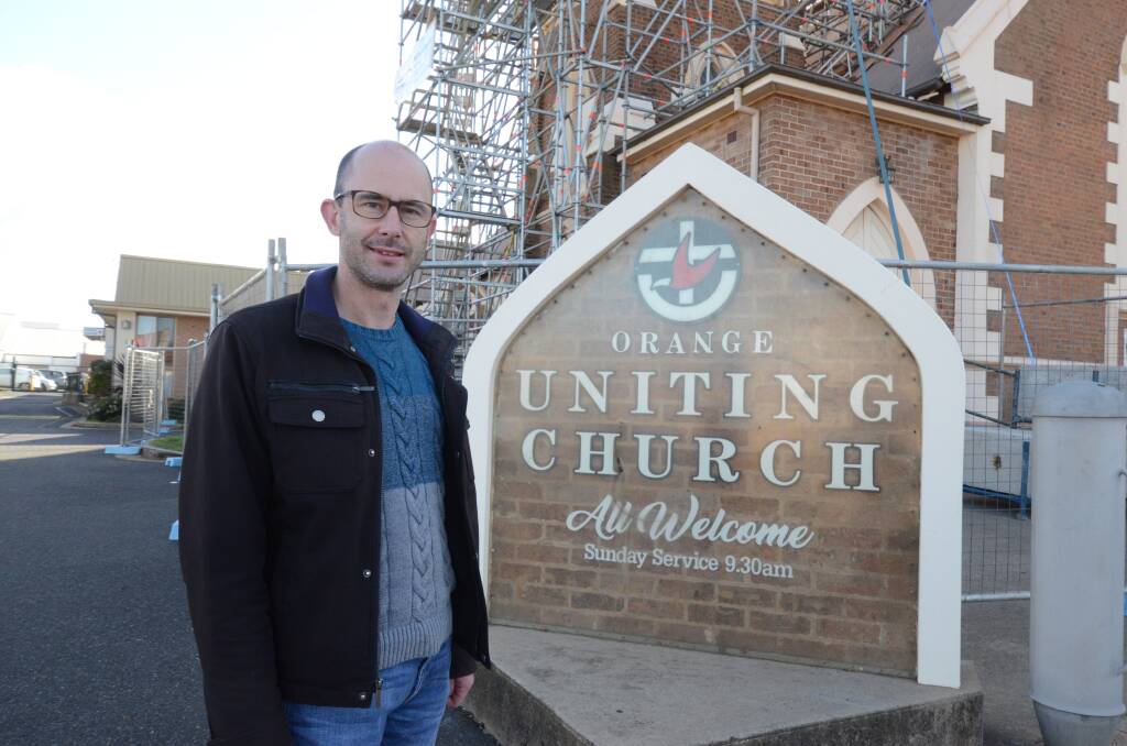 ONLINE ONLY: Reverend Andrew Cunningham outside the Orange Uniting Church which is undergoing renovations. Photo: JUDE KEOGH