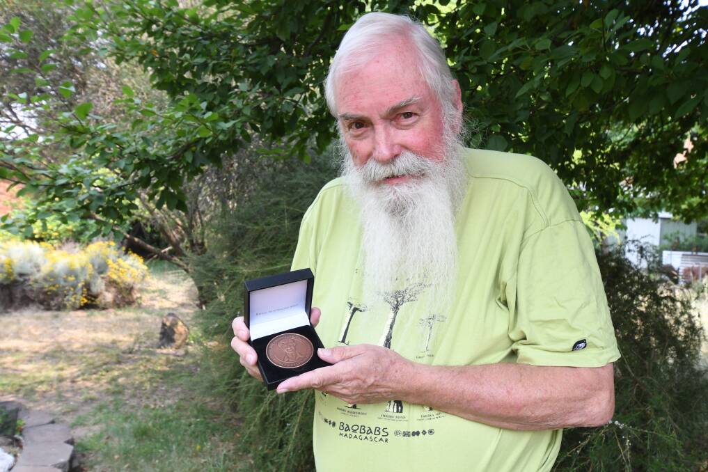 AWARD: Murray Fletcher with the Pat Marks Medal for lifetime achievement in entomology awarded to him in Brisbane last week. Photo: JUDE KEOGH 1211jkmurray3