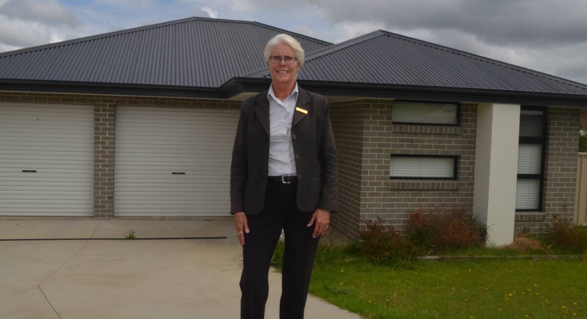 MONEY TALKS: Real estate agent Libby Seaman from Ray White Orange outside a house in Abelia Close on sale for $389,000. Photo: DAVID FITZSIMONS
