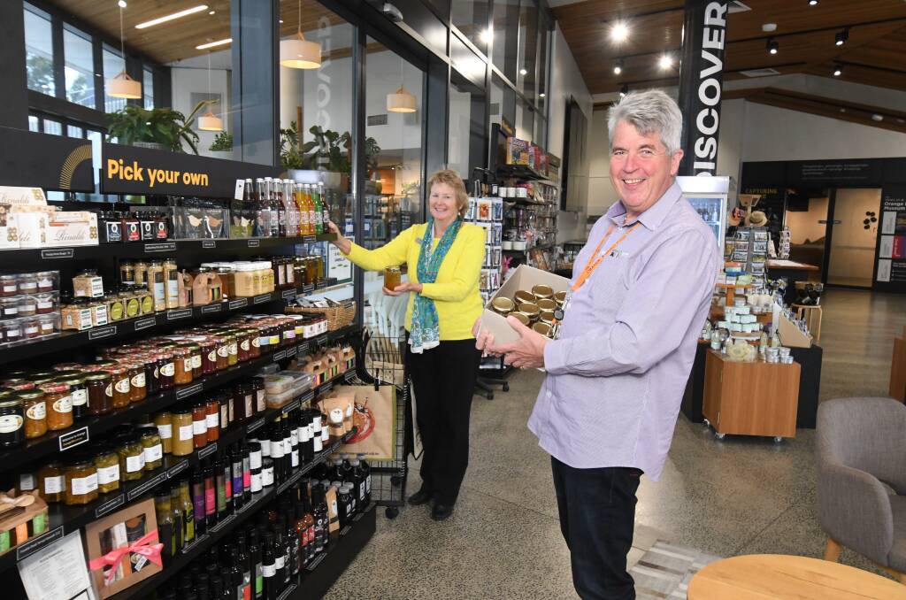 GETTING READY: Susan Perriman and Glen Mickle check the shelves in preparation for the re-opening of the Orange Visitor Information Centre. Photo: JUDE KEOGH