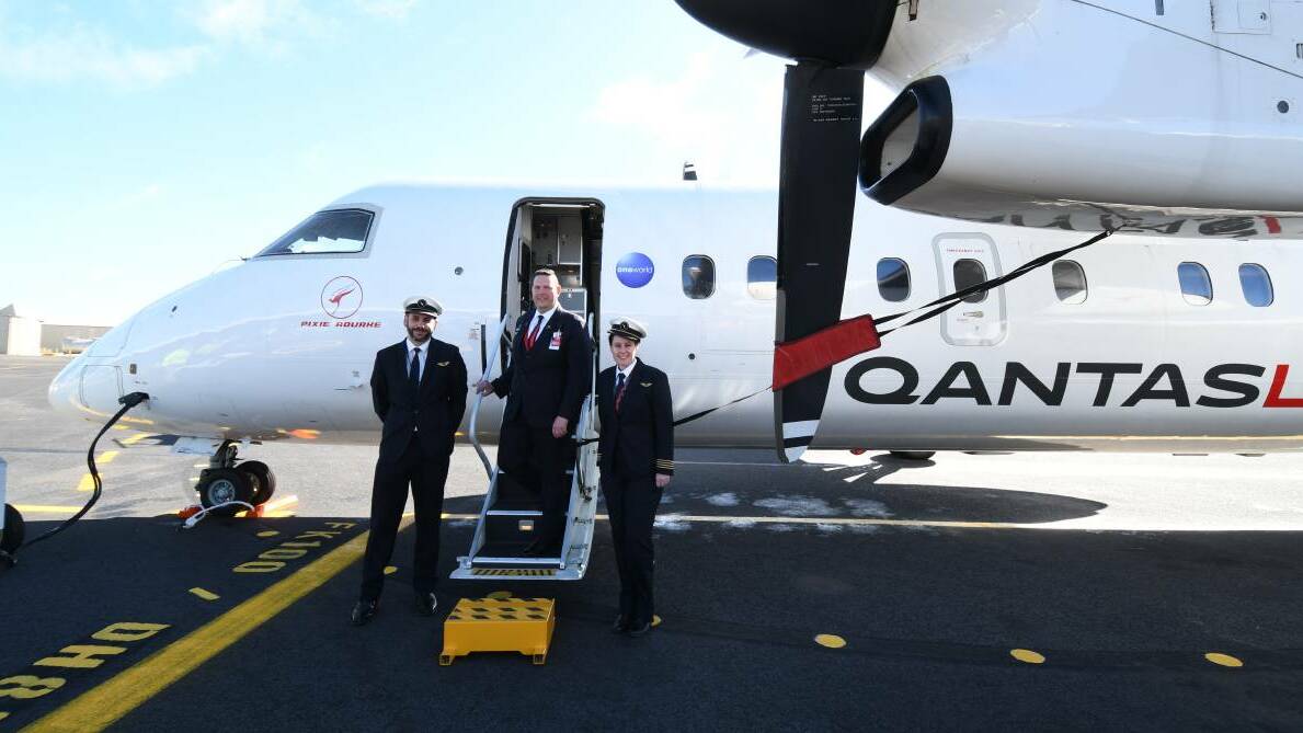 FIRST CREW: Flight attendant Damien Livermore (centre) with co-captains Dan McGowan and Corinne Pellatt with the first QantasLink flight to Orange in July 2020. Photo: CARLA FREEDMAN