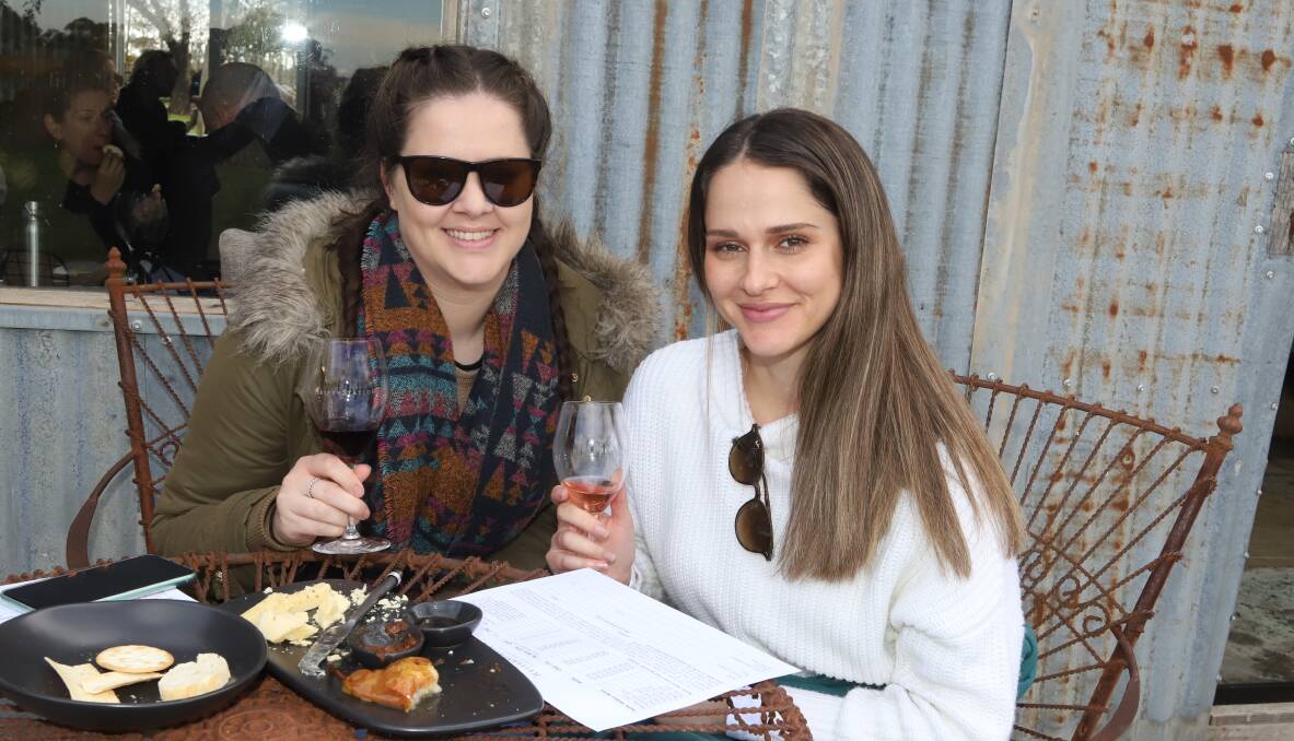 ENJOYING A TASTING: Emily Carruthers and Natalie Kapovic at Heifer Station's cellar door on the long weekend. Photo: CARLA FREEDMAN