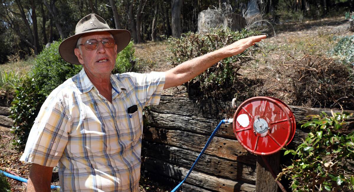 SAVED: Vigneron David Gartrell explains how close fire came to his property on Sunday. Photo: ANDREW MURRAY 0212amfire13