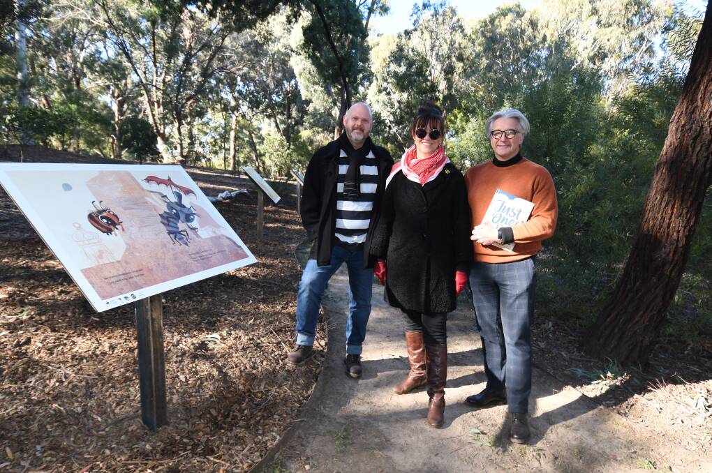 BOOK IN THE GARDEN: Christopher Nielsen, Margrete Lamond and Anthony Bertini in the story walk area of the Botanic Gardens. Photo: CARLA FREEDMAN