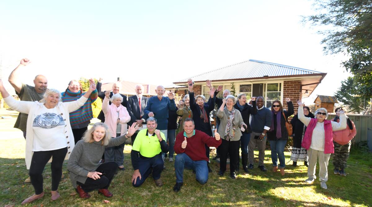 CELEBRATIONS: Deputy mayor Glenn Taylor and member for Orange Phil Donato (front) join residents and community members in cheering the government's backflip over social housing in East Orange. Photo: CARLA FREEDMAN