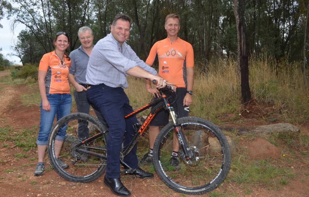 ON TWO WHEELS: Kim Broadfoot, Leo Presslaber and Joel Broadfoot with Member for Orange Phil Donato at the Lake Canobolas track. Photo: DAVID FITZSIMONS