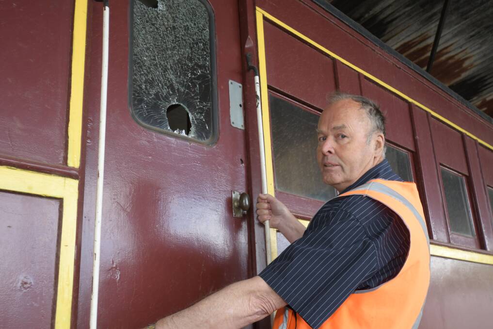 SMASHED: LVR volunteer Paul Fishlock examines the damage to one of the trains. Photo: CARLA FREEDMAN